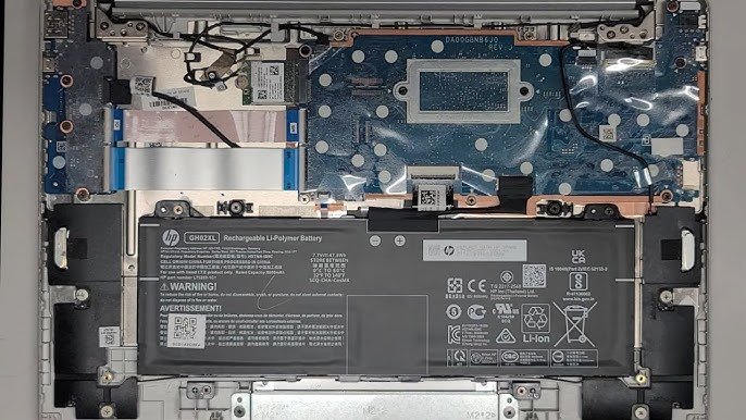 Technician opening Chromebook back panel with Torx screwdriver to inspect internal battery.